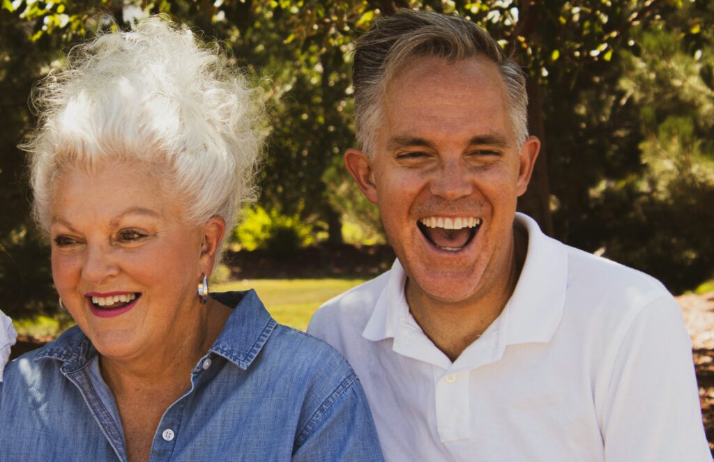 Adult woman and male laughing and showing their smiles